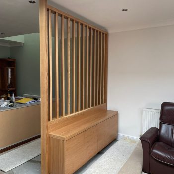 Oak slat wall room divider with base cabinet