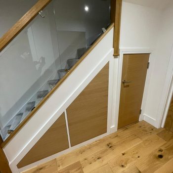 Bespoke under stairs storage units with Oak veneer to face of doors