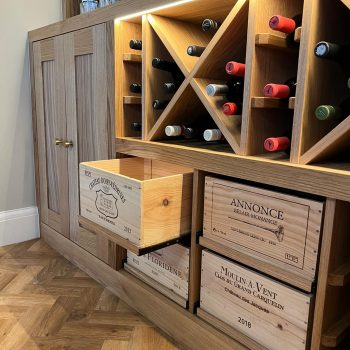Bespoke wine cabinet fitted under staircase with French wooden wine crates