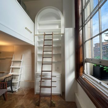 bespoke designed tall arched bookcase with library ladder