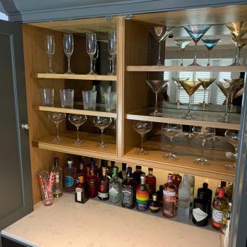 Drinks and wine glasses on display in a Bespoke Drinks cabinet