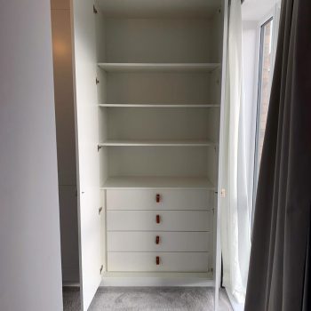 Bespoke wardrobe fitted with a drawer pack and adjustable shelves